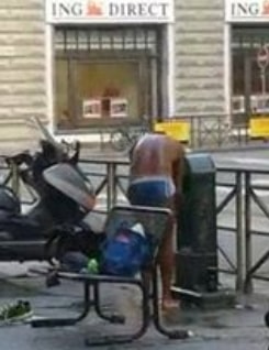 african man taking bath roadside italy